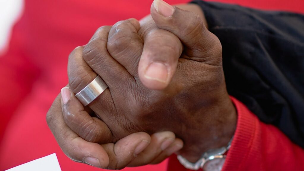 Two people holding hands